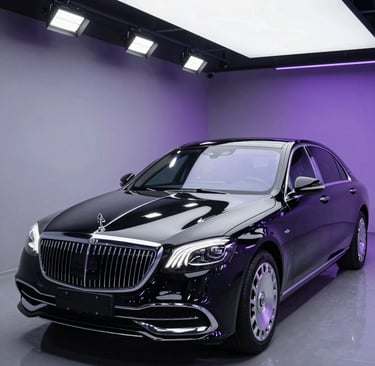 Luxury black Mercedes-Maybach S-Class sedan showcased in a professional studio with purple ambient lighting.