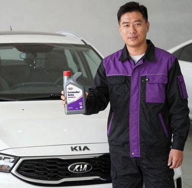 Professional mechanic holding a bottle of Lavender Auto motor oil in front of a white Kia car.