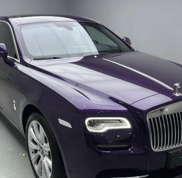 Hands carefully polishing a surface with purple and black tones softly blending.