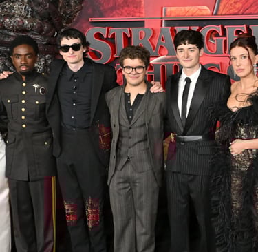 a group of people standing in front of a red carpet