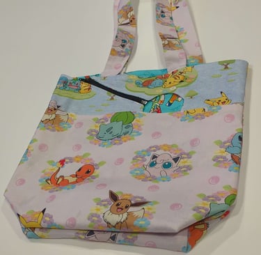 aphoto of a tote with an opening made out of pokemon fabric