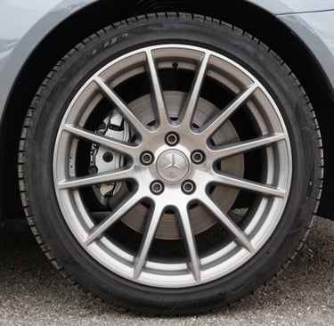 Close-up of a shiny black luxury sedan after a meticulous mobile detailing session under natural sunlight