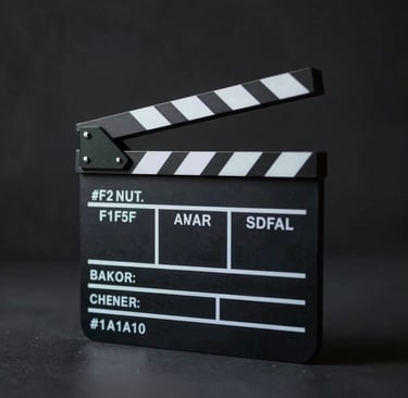 A sharp, high-contrast photo of a professional film clapboard sitting on a sleek, dark surface. The lighting is cinematic and moody, highlighting the edges with cool #F2F5F7 tones against a dark #1A1A1A backdrop, reflecting a modern production environment.
