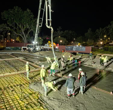 Drome image of workers pouring concrete slab
