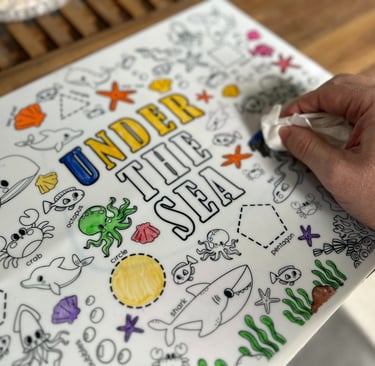 Wiping clean a Scribbly Kids reusable drawing mat for mess-free play and easy learning