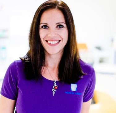 a woman in a purple shirt and a necklace