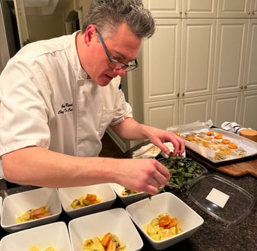 Chef Greg serving gnocchi and shrimp