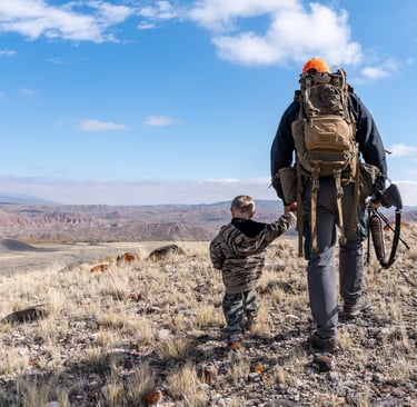 father and son walking to go hunting