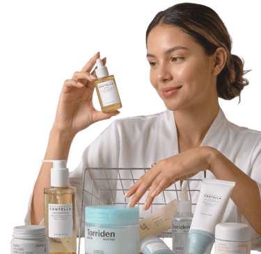 Woman holding a Korean skincare face serum bottle next to a basket of K-beauty products.
