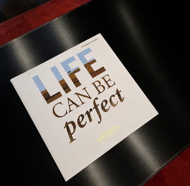 Champagne Bollinger coffee table book on a glossy black surface, creating a refined luxury lifestyle scene.