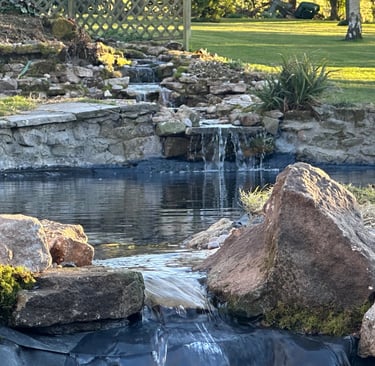Custom made waterfall water feature through 3 tear stacked ponds from big waterfall