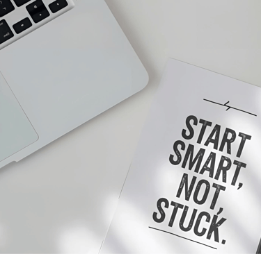 a notebook with a pen and a pen on a desk