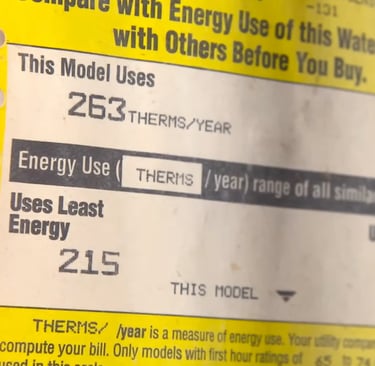 Yellow Energy Guide label on a water heater showing energy use of 263 therms per year.