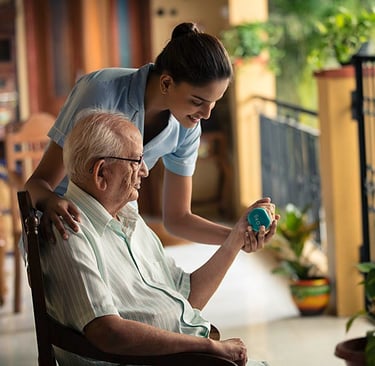 A young caregiver assisting a senior man with light weightlifting exercises for geriatric physical therapy.