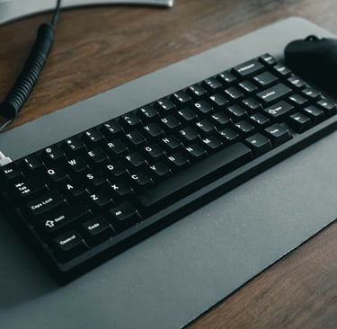 a keyboard and mouse mouse pad on a desk