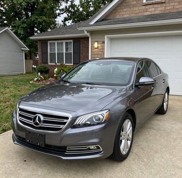 Nick in his purple-themed uniform carefully cleaning a car’s interior inside a cozy driveway.
