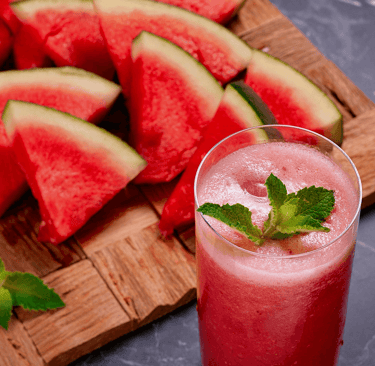 a glass of watermelon with a slice of watermelon