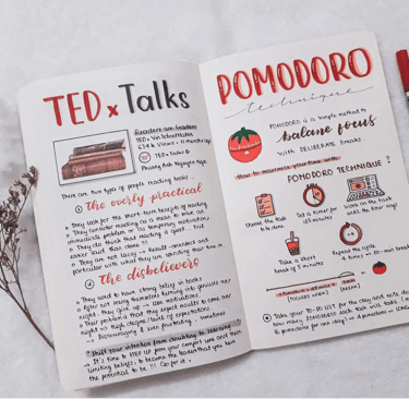 a notebook with a notebook and pens on it