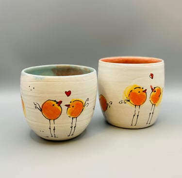 two cups of coffee with birds on them