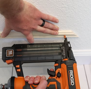 Carpenter installing interior trim molding with nail gun Irmo Columbia SC — Ironclad Trade Works