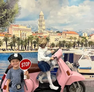 Kids on a vintage pink Vespa at Selfie Experience Split – fun family activity in Split Old Town