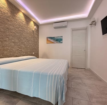 Camera da letto di appartamento vacanze con aria condizionata a Longobardi Marina