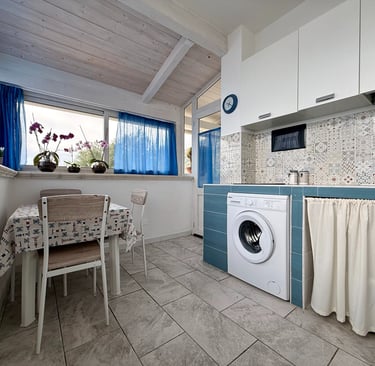 Cucina attrezzata in appartamento vacanze con frigorifero e lavatrice