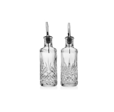 Pair of elegant cut glass bitters bottles with stainless steel pourers for craft cocktails.