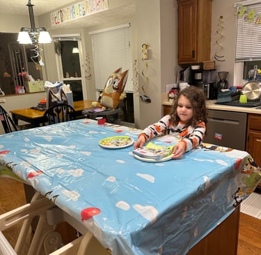 big sister helping decorate for siblings birthday party tradition