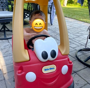 Toddler playing with Little Tikes Coupe