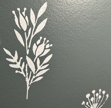 White floral wall stencil over custom grey-blue paint in half bath