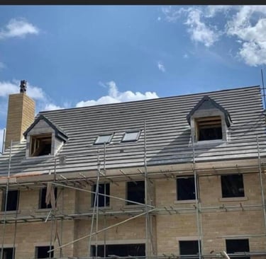 Roofing Specialist Yorkshire. showing a new roof being installed on a house with 2 dormer windows