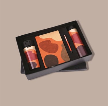 Vibrant new joinee kit with an artistic notebook, thermal flask, tumbler, and pen.