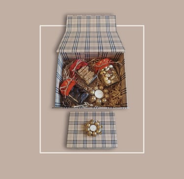 Monochrome plaid box filled with artisanal snacks for premium corporate festive gifting.