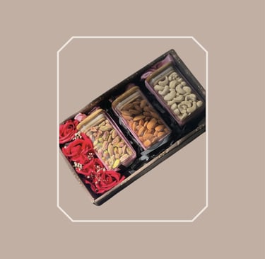 Elegant box gourmet food hamper featuring premium nuts and rose petals.