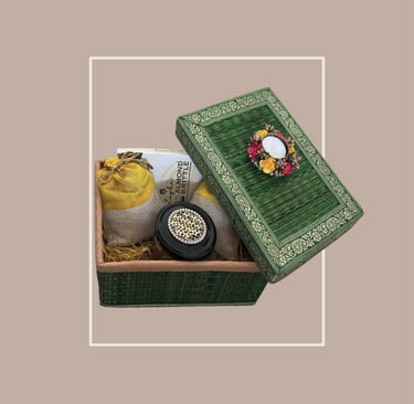 Emerald green textured gift trunk with almond brittle and festive gifting decor.