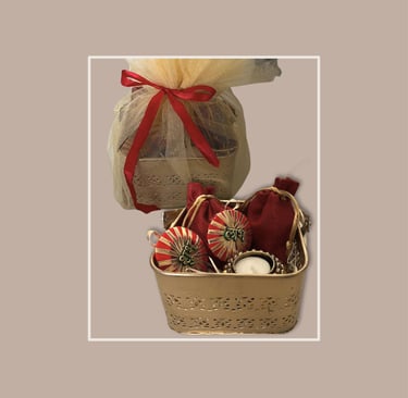 Golden filigree basket with traditional red potli bags for corporate festive gifting.