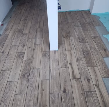 Elegant white interior featuring classic wall molding and a paneled door with vintage hardware.