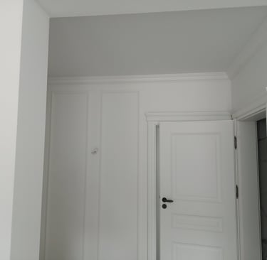 Modern bathroom renovation featuring a vertical chevron wood-look tile accent wall between white large format tiles.