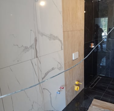 Modern minimalist interior staircase with grey walls, geometric architecture, and framed wall art.