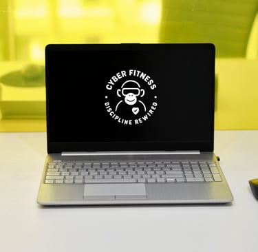 Cyber Fitness monkey logo on a laptop screen for digital discipline and mental wellness.