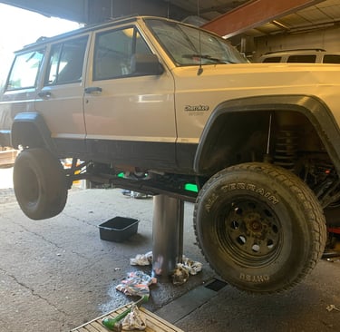Suv on a lift in the middle of an oil change