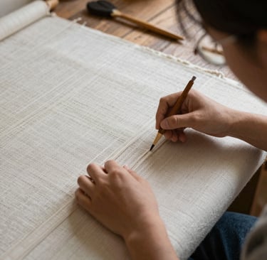 Handcrafted pottery pieces arranged on a rustic wooden table with natural light