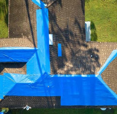 Roof tarp exclusion insurance homeowners claim aerial view