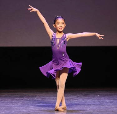 A young singer passionately performing on stage under warm spotlight.