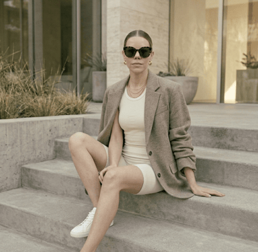Neutral sneakers paired with monochrome athleisure outfit and oversized blazer