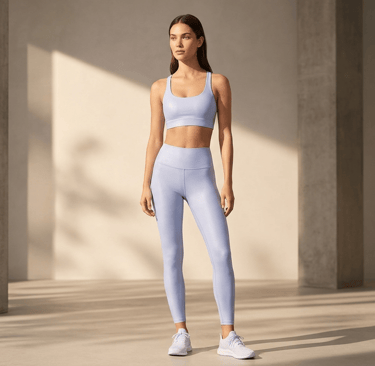 Female model wearing the Alo Yoga Light Provence Blue Airlift Line Up set in a high-end minimalist s