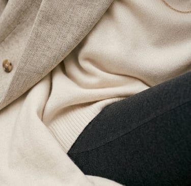 Close-up of premium neutral fabric textures in luxury minimalist fashion styling.