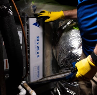our tech performing routine maintenance on a home air conditioning & heating system  in Arlington TX