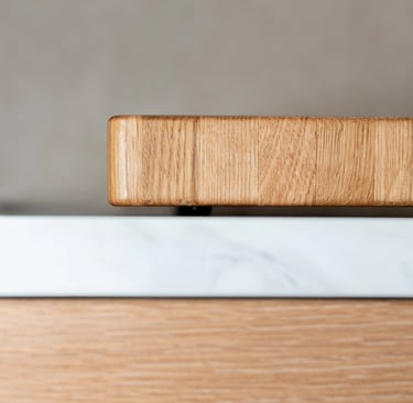 Close-up side view showing the thickness and rounded corner of a wooden chopping board